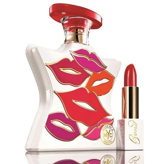 Perfume bottle and lipstick with colorful lip designs on a white background
