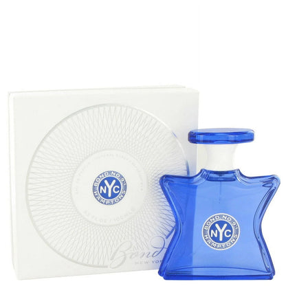Blue perfume bottle with 'NYC' logo next to its packaging on a white background