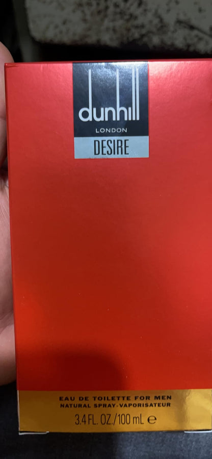 Red Dunhill Desire perfume box held in a hand